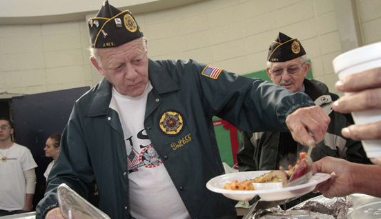 Veterans serving a meal